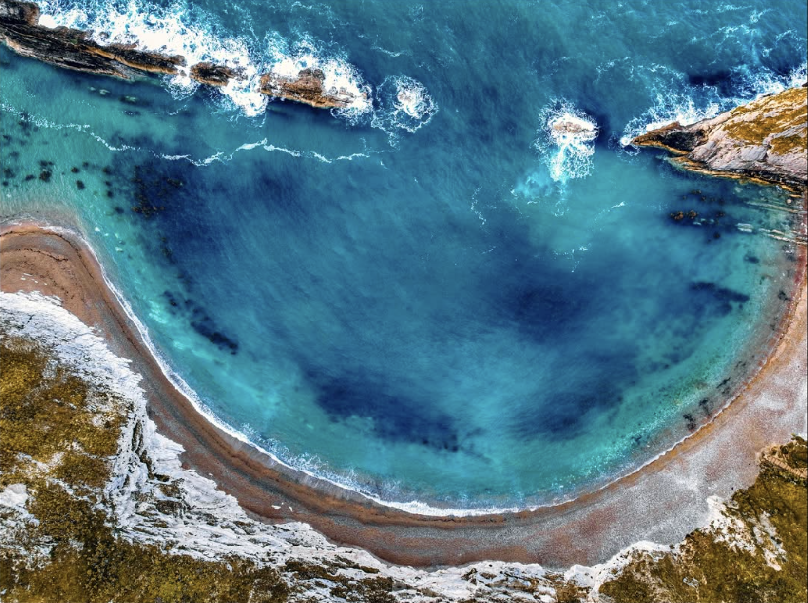 Aerial rock formation and coastline by B. Square